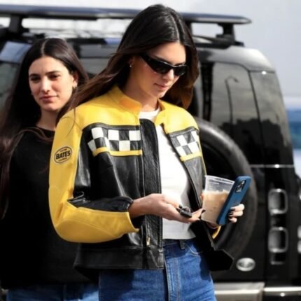 Kendall Jenner wearing a black and yellow leather jacket, front view
