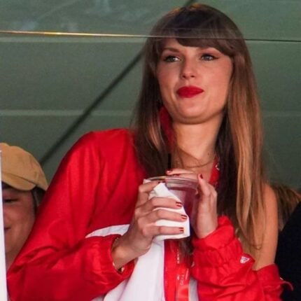 Taylor Swift in a red Kansas City Chiefs jacket with white accents