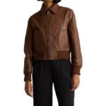 Women’s brown cropped leather bomber jacket with long sleeves, shirt collar and ribbed hem.