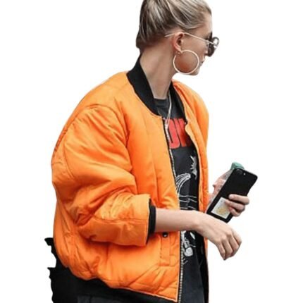 Hailey Baldwin wearing orange jacket side view