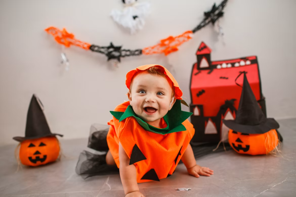 Baby in pumpkin Halloween costume for childrens halloween trivia