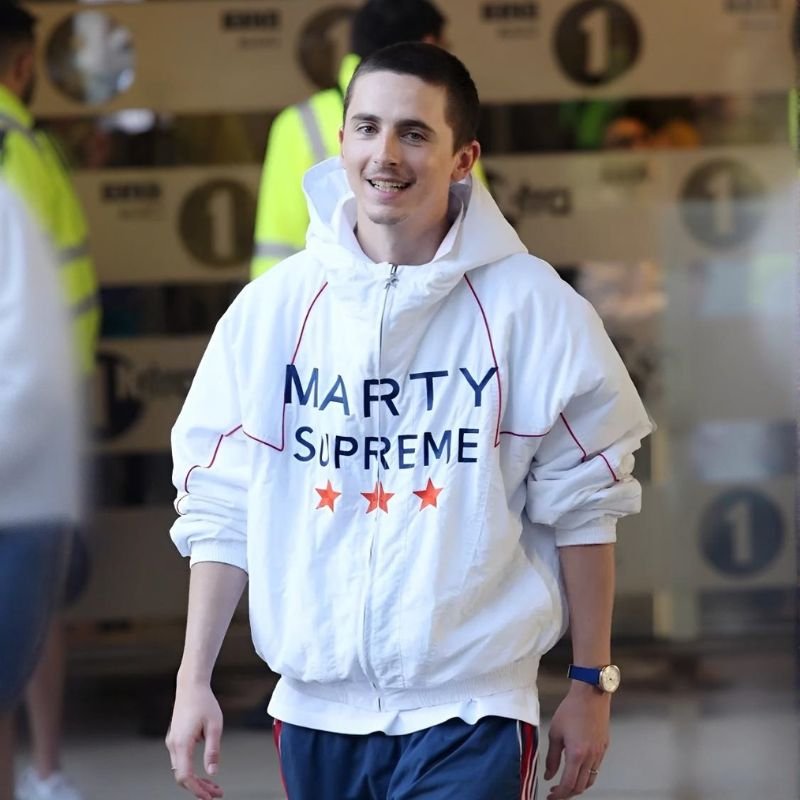 Marty-Supreme-Timothee-White-Jacket Front view of Timothée Chalamet wearing the Marty Supreme White Jacket with a hooded design, front zipper, and clean white finish.