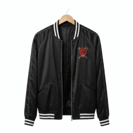 Front view of a black satin Okinawa bomber jacket with a striped ribbed collar, cuffs, waistband, front zipper, and red oni mask chest graphic.