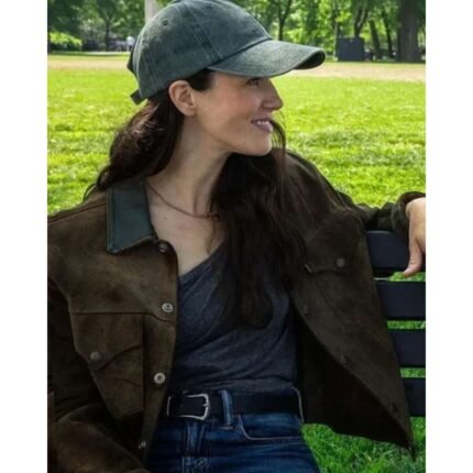 Jessica Brown Findlay wearing a brown suede jacket with front pockets and button closure