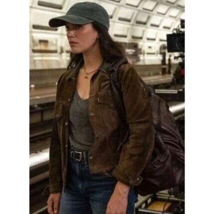 Jessica Brown Findlay wearing a brown suede jacket with a dark collar and front pockets outdoors