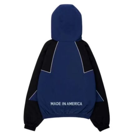 Back view of the blue Marty Supreme Jacket showcasing the hooded design, color-block pattern, and elastic waistband.