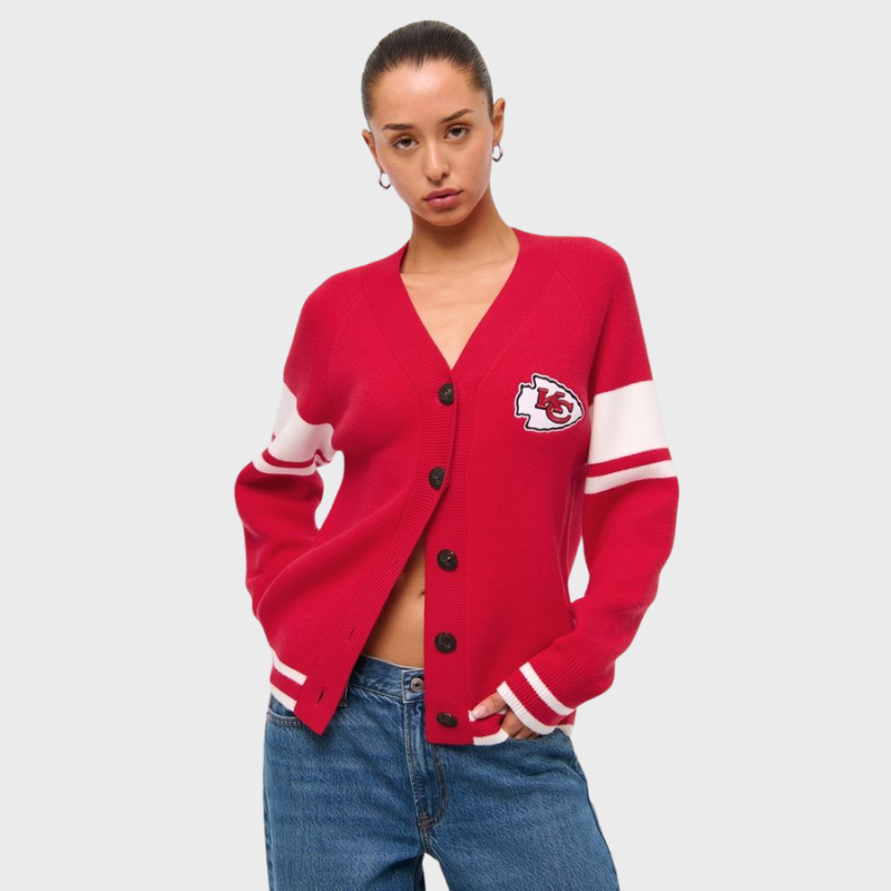 kansas-city-chiefs-luxe-loft-red-cardigan Woman wearing a red Kansas City Chiefs cardigan with white sleeve stripes and front logo patch