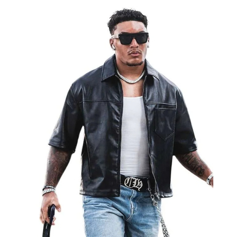 Braelon-Allen-2026-Black-Leather-Jacket Black leather short-sleeve jacket worn over a white shirt with blue jeans, styled as a bold casual streetwear look.