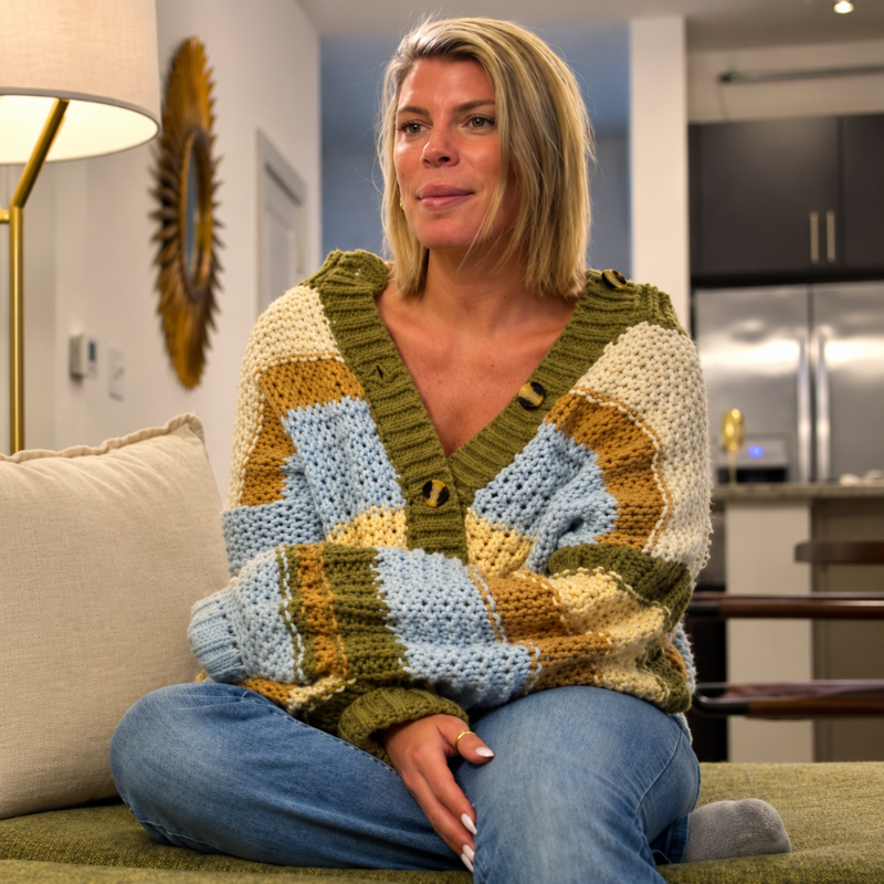 Erika-ellis-love-is-blind-season-11-cardigan Woman wearing a chunky patchwork knit cardigan in olive green, cream, mustard, and light blue with a V-neck and button front.