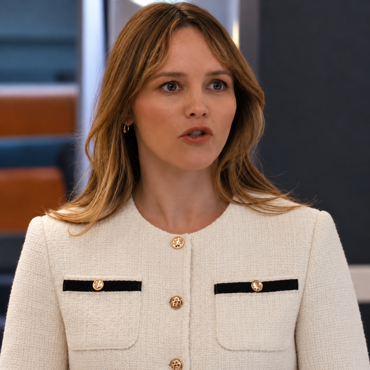 Mallory-sloan-chicago-med-season-12-tweed-jacket Mallory Sloan wearing an ivory tweed jacket with black-trimmed pockets and decorative gold-tone buttons in Chicago Med Season 12-inspired styling.