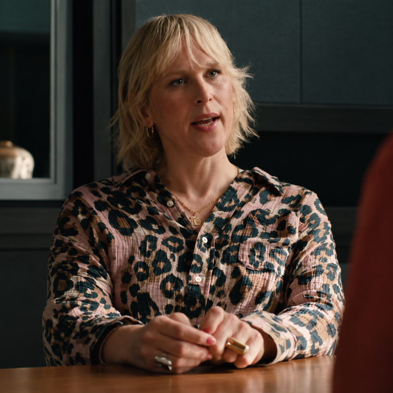 Renee-lum-elsbeth-season-4-printed-shirt Renee Lum wearing a pink and brown leopard print button-up shirt in Elsbeth Season 4