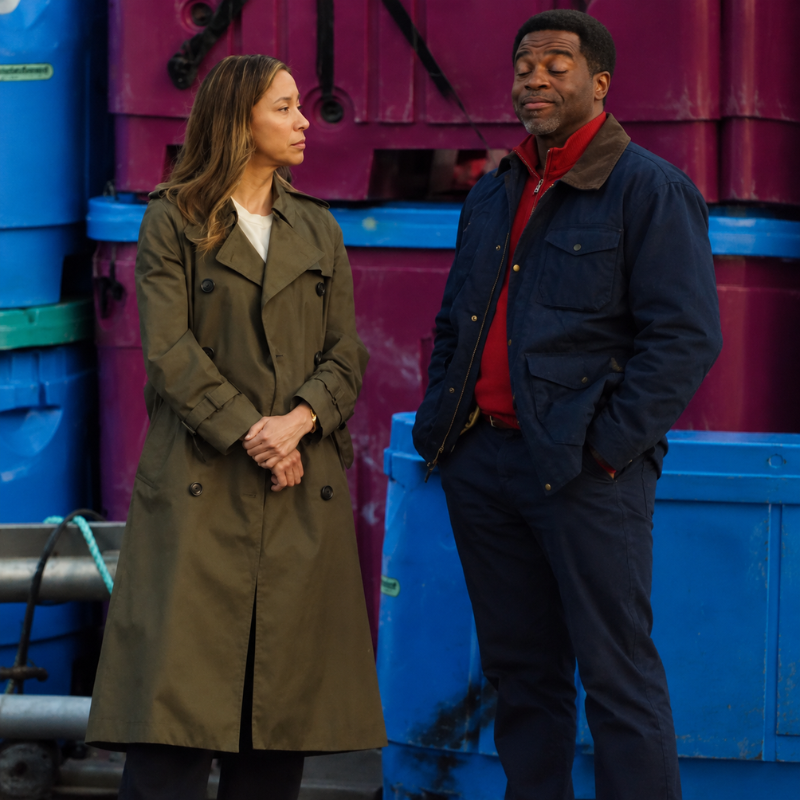 Sarah-truong-hudson-and-rex-season-9-trench-coat Sarah Truong-inspired olive green trench coat worn with a white top in a scene inspired by Hudson and Rex Season 9.