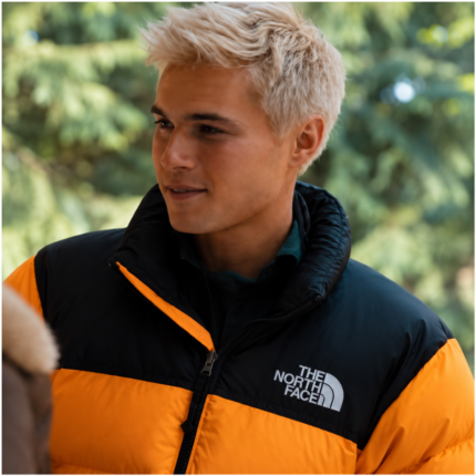 Theo in a Holidaze gold black retro puffer jacket worn by a male model