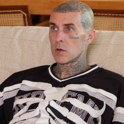 Travis Barker inspired black skeleton hockey jersey with white ribcage graphics and striped sleeves.
